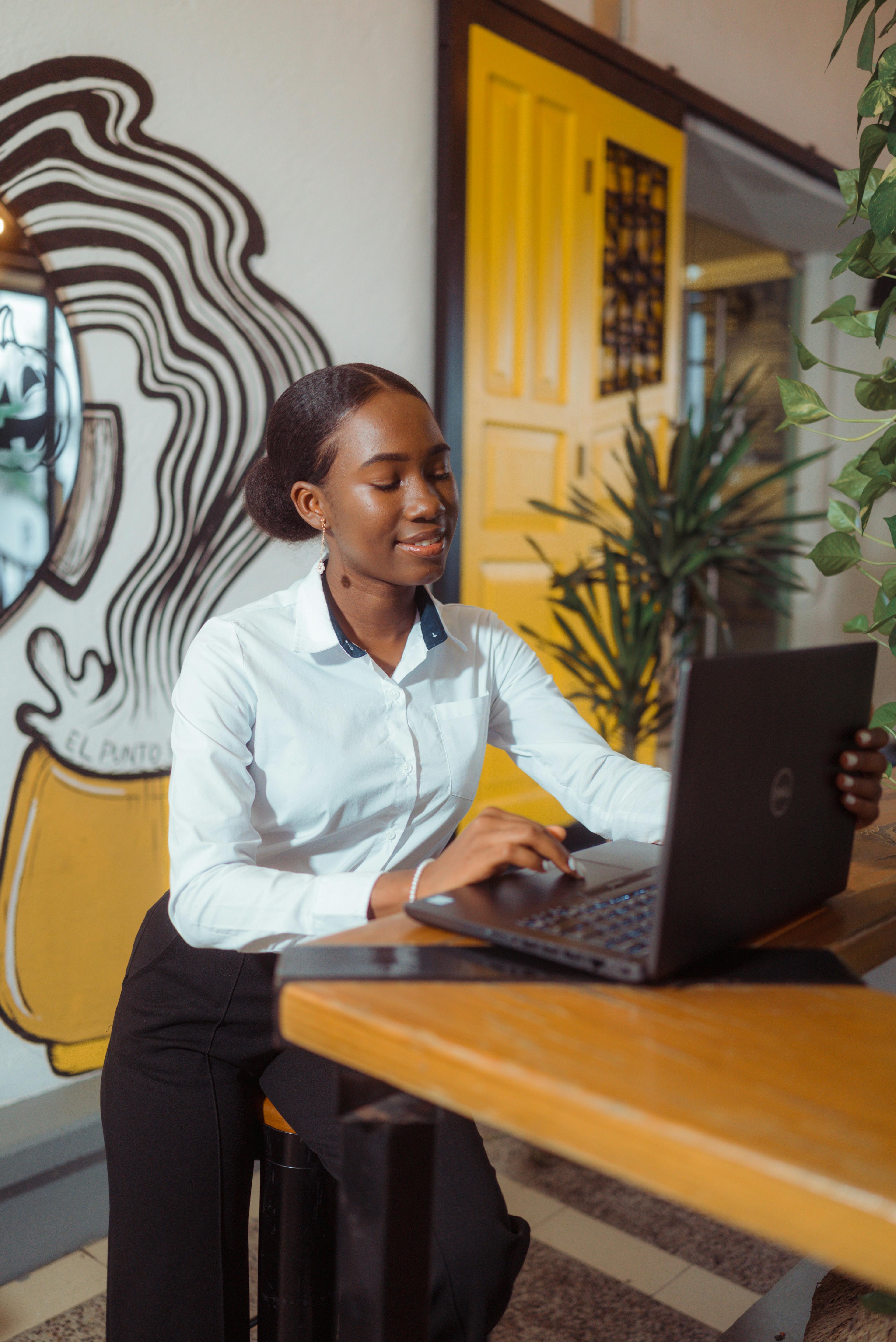 A virtual assistant focused on her work at a laptop